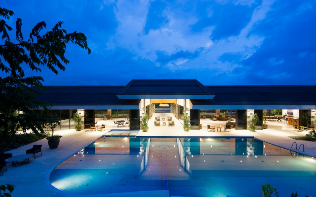 blue body of water in front of building near trees during nighttime